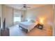 Comfortable bedroom with carpet, ceiling fan, window and modern furniture at 735 Woodmoor Acres Dr, Monument, CO 80132