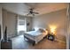 Cozy bedroom features a ceiling fan, bedside table, and natural light from the window at 735 Woodmoor Acres Dr, Monument, CO 80132