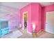 Bright pink bedroom with whimsical mural and view into walk-in closet at 735 Woodmoor Acres Dr, Monument, CO 80132