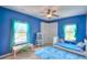 Charming bedroom with blue walls, a window view, and whimsical decor at 735 Woodmoor Acres Dr, Monument, CO 80132