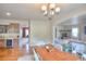 Dining area featuring hardwood floors and offering seamless transition to an adjacent living area and kitchen at 735 Woodmoor Acres Dr, Monument, CO 80132