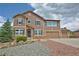 Charming two-story home with a stone-accented entrance and three-car attached garage at 735 Woodmoor Acres Dr, Monument, CO 80132
