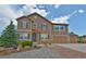 Charming two-story home with stone accents, three-car garage, and a beautifully landscaped front yard at 735 Woodmoor Acres Dr, Monument, CO 80132