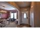 A charming foyer with wood floors that opens to a dining room with a modern light fixture at 735 Woodmoor Acres Dr, Monument, CO 80132