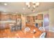 Open kitchen boasts hardwood floors, center island with granite countertop, and stainless steel appliances at 735 Woodmoor Acres Dr, Monument, CO 80132