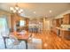 Spacious kitchen with an eat-in table, wood flooring, stainless steel appliances, and light-colored cabinets at 735 Woodmoor Acres Dr, Monument, CO 80132