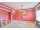 A formal living room featuring bright paint, carpet, trim, and a contemporary lighting fixture at 735 Woodmoor Acres Dr, Monument, CO 80132