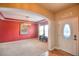 Inviting living area with stylish light fixture, large window, and neutral carpet flooring at 735 Woodmoor Acres Dr, Monument, CO 80132