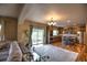 Bright living room with large windows, hardwood floors, and a view to the kitchen at 735 Woodmoor Acres Dr, Monument, CO 80132