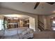 Open-concept living room flows into a spacious kitchen with stainless steel appliances and hardwood floors at 735 Woodmoor Acres Dr, Monument, CO 80132