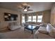 A spacious living room features a comfortable sectional sofa, plush carpet, and lots of natural light at 735 Woodmoor Acres Dr, Monument, CO 80132