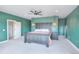 Green main bedroom features plush carpeting, ceiling fan, and coordinated furniture for a relaxing retreat at 735 Woodmoor Acres Dr, Monument, CO 80132