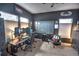 A modern office space features a desk, multiple monitors, neutral carpet and dark accent walls at 735 Woodmoor Acres Dr, Monument, CO 80132