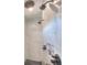 Contemporary shower with multiple shower heads, marble-like tile, and a recessed shelf at 735 Woodmoor Acres Dr, Monument, CO 80132