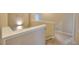 Bright stairwell featuring neutral walls, white trim, and carpeted stairs, creating an inviting transition between floors at 735 Woodmoor Acres Dr, Monument, CO 80132