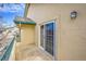Balcony with sliding glass door and neutral stucco walls, offering outdoor living space at 8747 E Dry Creek Rd # 1623, Englewood, CO 80112