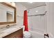 Bathroom with a vanity, granite counters, a tile backsplash, and a shower with a patterned accent row at 8747 E Dry Creek Rd # 1623, Englewood, CO 80112