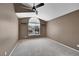 Bedroom with carpet, vaulted ceiling, ceiling fan and a large arched window for natural light at 8747 E Dry Creek Rd # 1623, Englewood, CO 80112
