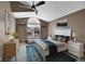 A bright and airy main bedroom featuring a large window, neutral paint, carpet, and ceiling fan at 8747 E Dry Creek Rd # 1623, Englewood, CO 80112