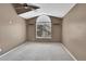 Bedroom with carpet, vaulted ceiling, ceiling fan and a large arched window, well lit space at 8747 E Dry Creek Rd # 1623, Englewood, CO 80112
