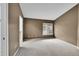 Spacious carpeted bedroom with a neutral color scheme and view of a closet with glass shower doors at 8747 E Dry Creek Rd # 1623, Englewood, CO 80112