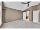 Bedroom featuring carpet, ceiling fan, and a barn door leading to the bathroom, providing a modern touch at 8747 E Dry Creek Rd # 1623, Englewood, CO 80112