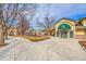 Clubhouse with a green awning and glass doors surrounded by a walkway, trees, and meticulous landscaping at 8747 E Dry Creek Rd # 1623, Englewood, CO 80112