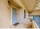 Exterior shot of a front door with a blue-gray finish, positioned beside a window and a blue-gray railing at 8747 E Dry Creek Rd # 1623, Englewood, CO 80112