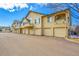 Exterior view of townhomes, each with a private garage, a balcony, and neutral paint at 8747 E Dry Creek Rd # 1623, Englewood, CO 80112