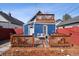 Charming backyard with a wooden deck, outdoor seating, and well-manicured landscaping at 1144 S Logan St, Denver, CO 80210