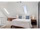 Bright bedroom with skylights, neutral color palette, and hardwood accents at 1144 S Logan St, Denver, CO 80210