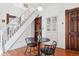 Cozy dining area with elegant staircase, modern table, and vintage wood accents at 1144 S Logan St, Denver, CO 80210
