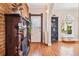 Inviting entryway showcasing a decorative fireplace, hardwood floors, and a view of the living room at 1144 S Logan St, Denver, CO 80210
