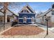 Charming blue home featuring a well-manicured front yard with outdoor seating and a welcoming facade at 1144 S Logan St, Denver, CO 80210
