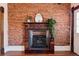 Charming fireplace with ornate wood trim and exposed brick wall in a historic home at 1144 S Logan St, Denver, CO 80210