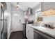 Updated kitchen with white cabinets, stainless steel appliances, and modern fixtures at 1144 S Logan St, Denver, CO 80210