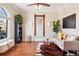 Bright and airy living room with hardwood floors, large windows, and tasteful decorative accents at 1144 S Logan St, Denver, CO 80210