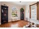 Bright living room featuring hardwood floors, large windows, and stylish bookshelves for organized storage at 1144 S Logan St, Denver, CO 80210