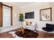 Cozy living room featuring a comfortable couch, hardwood floors, and stylish decor for a welcoming ambiance at 1144 S Logan St, Denver, CO 80210