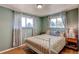 Cozy bedroom with wood floors, ample natural light, and neutral wall color at 7106 Reed Cir, Arvada, CO 80003