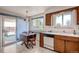 Cozy kitchen with wood cabinets, laminate floors, and a window over the sink at 7106 Reed Cir, Arvada, CO 80003