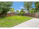 Grassy backyard with a wood fence and a small patio area at 7507 Braun St, Arvada, CO 80005