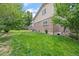 View of the backyard with lush green grass and mature landscaping at 7507 Braun St, Arvada, CO 80005