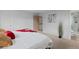 Bright bedroom showcasing bathroom access, a bed, carpeted floors, and neutral paint at 7507 Braun St, Arvada, CO 80005