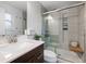 Updated bathroom featuring a glass shower enclosure, sleek vanity, and modern fixtures at 7507 Braun St, Arvada, CO 80005