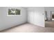 Inviting bedroom featuring soft carpet, a window with green views, and a closet with ample storage at 7507 Braun St, Arvada, CO 80005