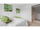 Cozy bedroom showcasing two abstract paintings, a bed, carpeted floors, and neutral paint at 7507 Braun St, Arvada, CO 80005