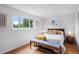 Bedroom with wood floors, and lots of natural light showcasing views to the outside at 7507 Braun St, Arvada, CO 80005