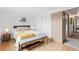 Comfortable bedroom with a white bedspread and wood-look flooring at 7507 Braun St, Arvada, CO 80005