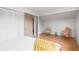 Cozy bedroom features natural light and blonde wood-look floors at 7507 Braun St, Arvada, CO 80005